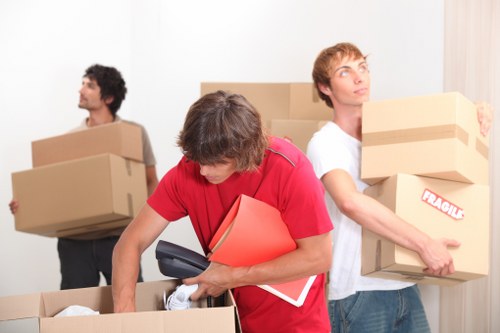 Boxes and household items being loaded into a removal vehicle